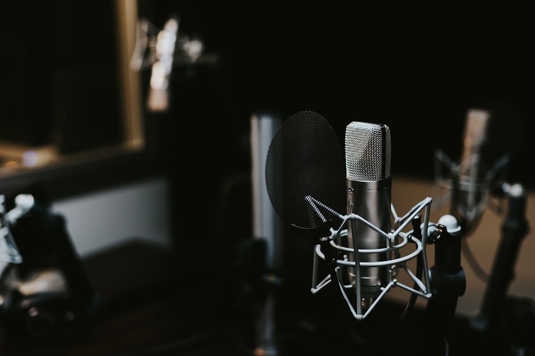 A studio microphone in moody lighting — the craft underneath every great clip.